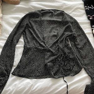 Black polka dot wrap-around blouse